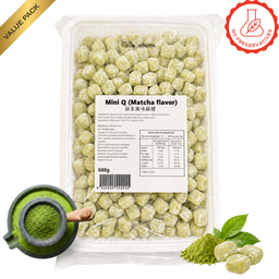 A clear plastic tub filled with matcha-flavored mini candies, shown on a white background with a product label, a green powder bowl graphic, and matcha leaves. A gold 'Value Pack' banner appears in the top-left corner, and a red 'No Preservatives' badge appears in the top-right.